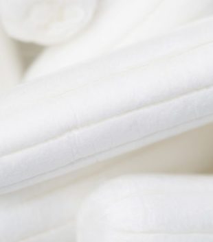 Pile of white tampons to question if organic tampons contain titanium dioxide which is used as a bleaching agent in some products