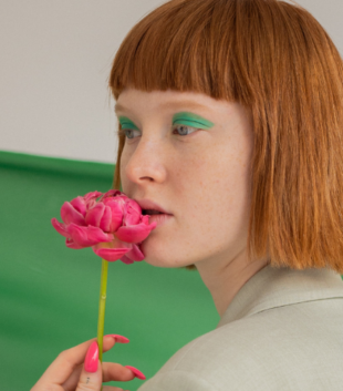 Fashionable girl with green background and flowert