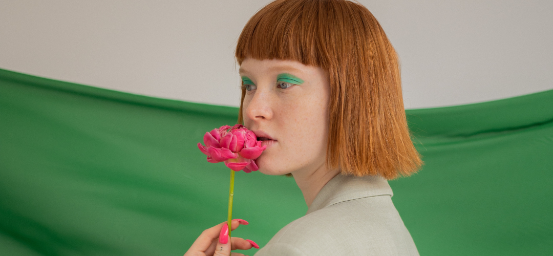 Fashionable girl with green background and flowert