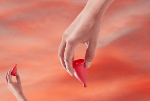 TOTM reusable zero waste menstrual cup on a red background