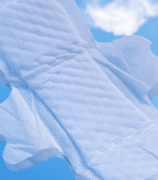 TOTM's light flow organic cotton pad out of wrapper on a blue background with cloud