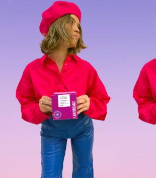 Girl in pink shirt and blue trousers holding TOTM super flow pad box for Tesco Express launch announcement